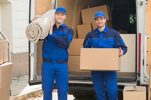 Professional movers carrying office items during a Roehampton relocation