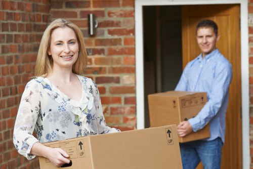 Furniture and boxes being transported by a Roehampton moving van