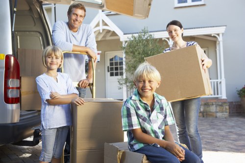 Packed moving boxes and furniture prepared for a Roehampton flat move