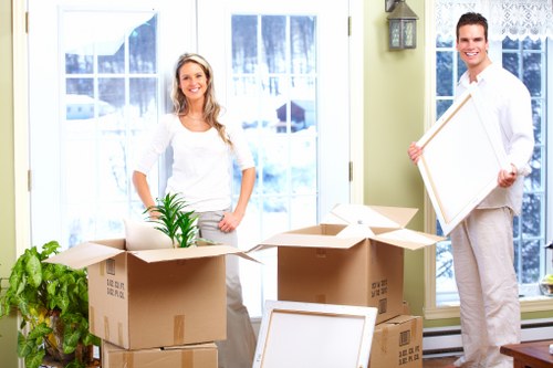 Movers carrying items through a Roehampton apartment building